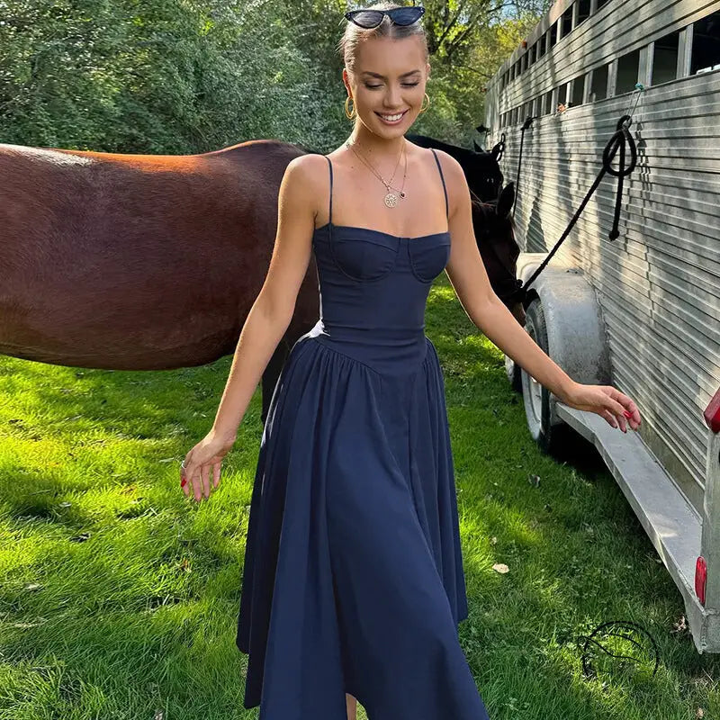 Navy blue midi backless sling dress on display