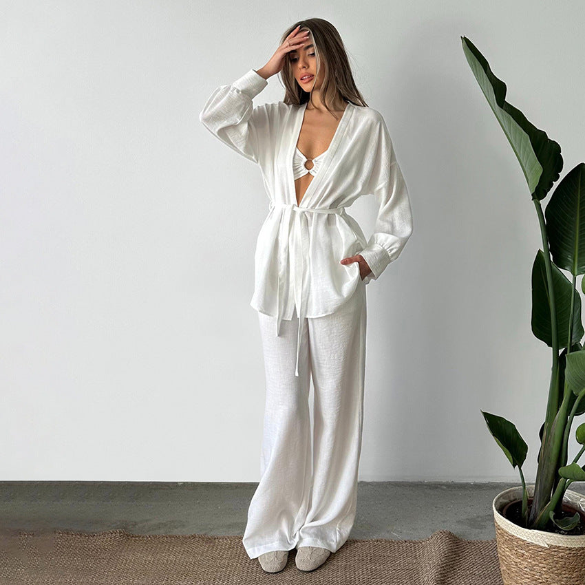 Woman in comfy cotton linen pajamas with tie-front top and wide-leg pants