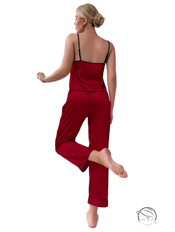 Red satin pajama set with black trim and black eye mask
