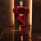 Red velvet off-shoulder long sleeve jumpsuit with fur accents and high slit