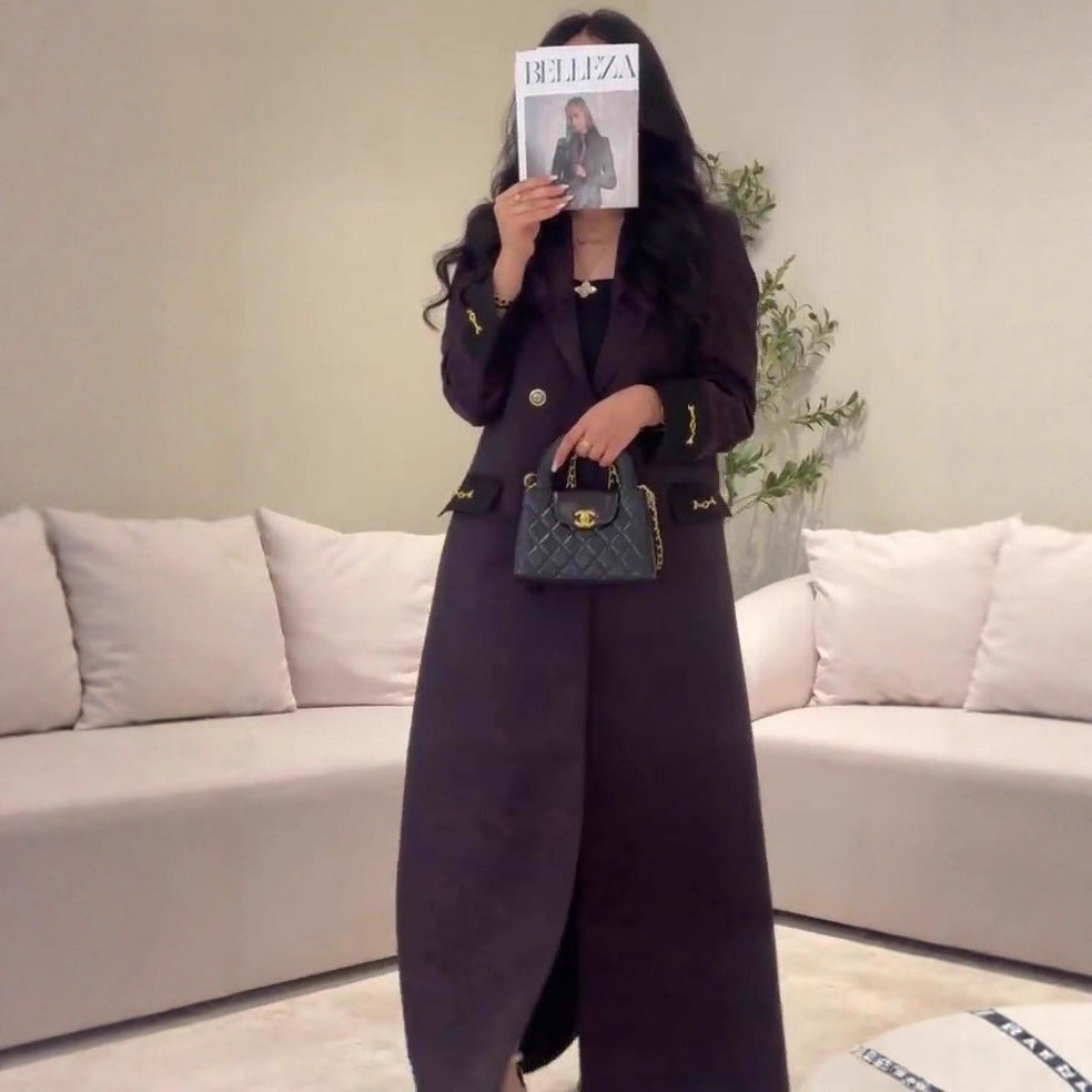 Black quilted Chanel handbag with gold hardware in Langry fashion trench coat