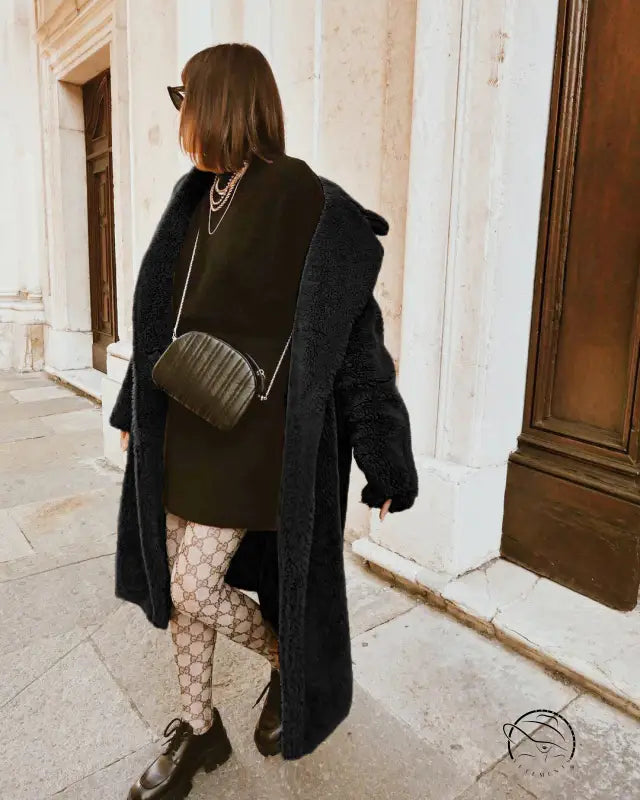 Black quilted crossbody bag with silver chain strap in Langry fashion faux fur coat