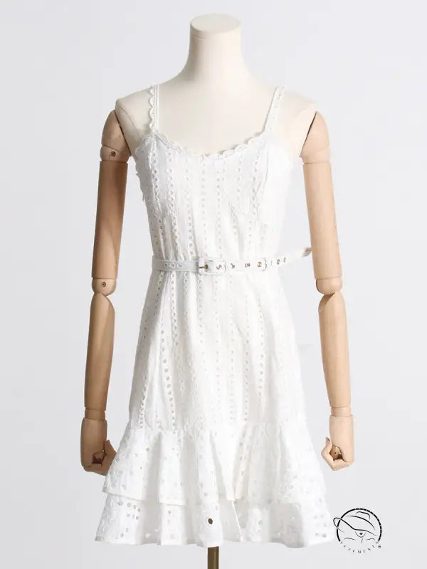 White eyelet lace summer machine embroidery sundress with ruffled hem and waist slimming design on mannequin