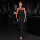 Strapless black sequined evening gown featuring a form-fitting silhouette for graceful fashion