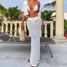 White crochet beach cover-up set featuring a bikini top and maxi skirt in fashionable langry
