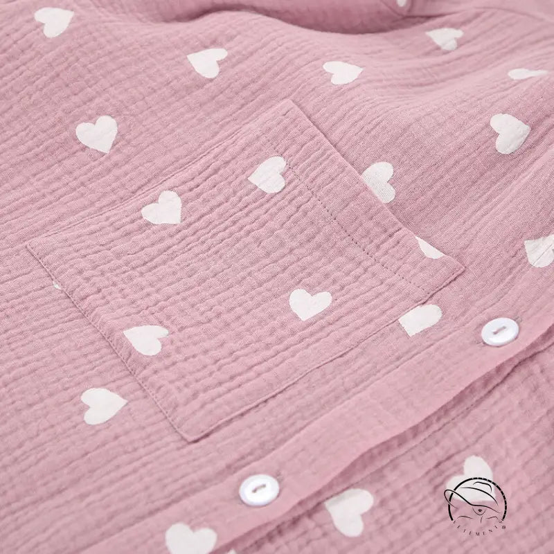 Pink crinkled cotton pajamas set with white hearts and buttons