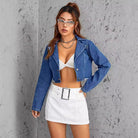 Woman wearing slimming short denim coat, cropped blue denim jacket, and stylish accessories