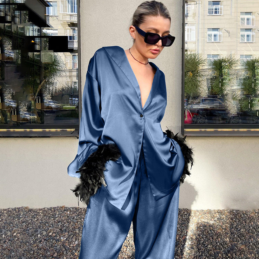 Langry blue satin jumpsuit with feather accents and deep v-neck fashion pajamas