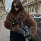 Cozy short faux fur coat with brown fur, black leather gloves and bag from Langry fashion