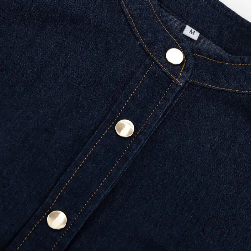 Dark blue denim shirt with band collar and gold snaps for fashionable dress