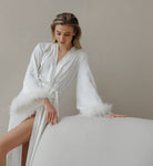 Elegant white feather-trimmed satin long sleeve robe in deep V-neck fashion