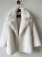 Elegant white faux fur jacket with classic collar and buttons by Langry fashion