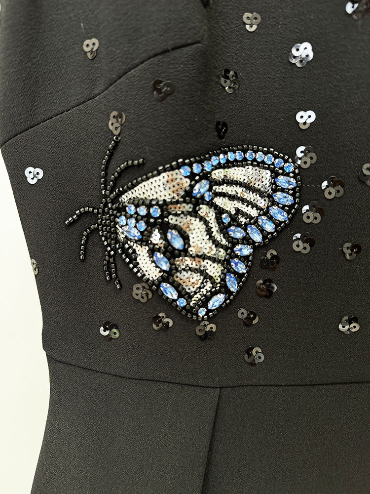 Black dress with beaded butterfly design, perfect for elegant fashion occasions in ملابس