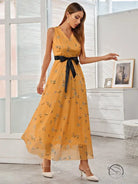Elegant long langry fashion dress: flowing yellow floral maxi with black satin belt