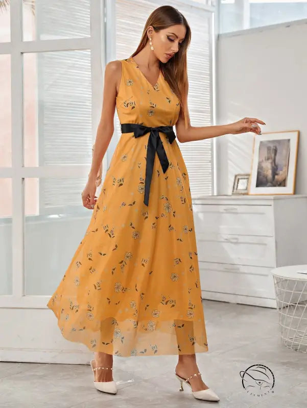 Elegant long langry fashion dress: flowing yellow floral maxi with black satin belt