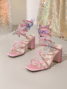 Pink glittery Langry fashion stiletto heels with rhinestone bow and butterfly accents