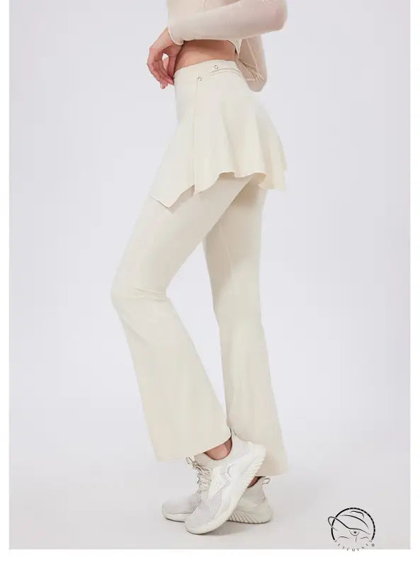 Cream-colored hip lifting yoga pants with nude feel and flared ruffled hem