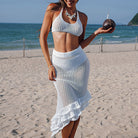 White crochet beach two-piece outfit with crop top and ruffled skirt for trendy summer fashion