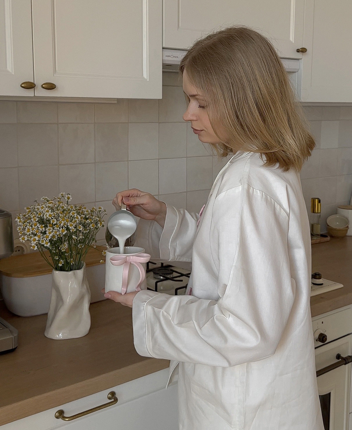 Elegant white ceramic vase with floral arrangement in Langry fashion pajamas display