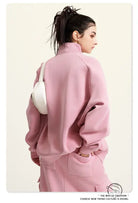 Pink winter heavy retro jacket with oversized turtleneck and white handbag