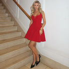 Woman in red dress wearing the Enchanting Slimming Sling Dress, a stylish fashion choice