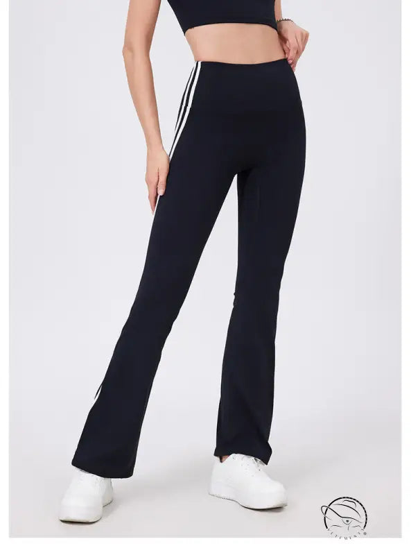 Black high-waist yoga pants with white stripes and peach hip raise