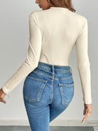 Cream ribbed langry fashion bodysuit with high-waisted jeans