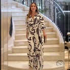 Woman in high waist black and white floral patterned jumpsuit