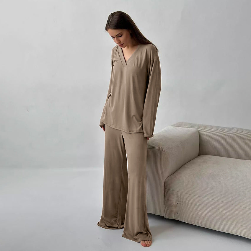 Woman modeling comfortable knitted pajamas in beige with long sleeves and wide-leg pants