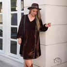Woman in brown velvet dress and wide-brimmed hat, loose slimming casual style
