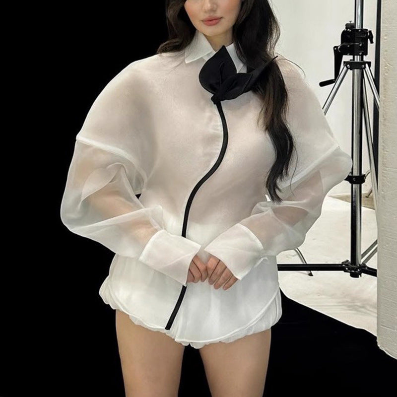 White sheer langry fashion blouse with black trim and ruffled hem