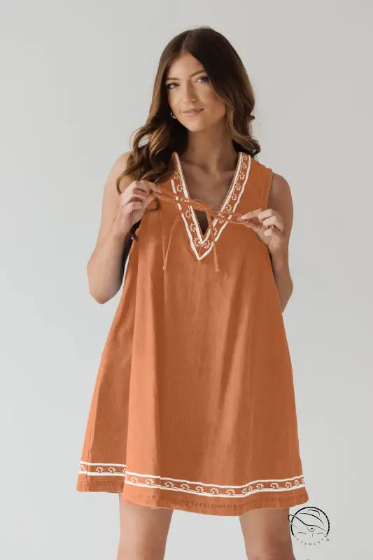 Beautiful embroidered vest denim dress with orange sleeveless design and white trim