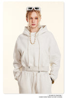 White hooded sweatsuit with sweatpants and layered necklace in Langry fashion ملابس