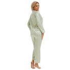 Woman in light green langry fashion pajamas with bold stripes