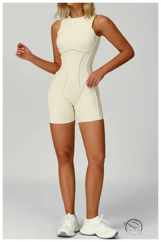 White langry fashion yoga jumpsuit with beauty back cutout and sneakers