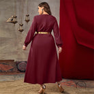 Casual loose high waist A line dress in flowing maroon satin with long sleeves and gold belt