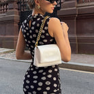 Cream crossbody bag with gold chain strap and Langry logo