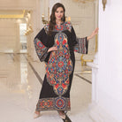 Elegant loose black kaftan dress with colorful floral pattern and bell sleeves