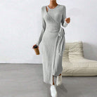 Warm knitted gray maxi dress with long sleeves, side slit, and self-tie waistband