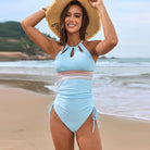 Light blue attractive one-piece swimsuit with decorative cutouts and ruched side ties