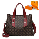 Langry brown and red monogrammed soft leather handbag with fashion accents