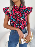 Vibrant casual leopard print blouse with pink, black, teal pattern and pussy bow neckline