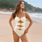 Cream-colored one-piece swimsuit with cutouts, perfect for summer fashion and ملابس