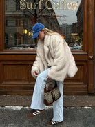 Fashionable faux fur coat with beige Gucci shoulder bag