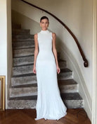 Elegant sleeveless white maxi dress with pleated skirt detailing