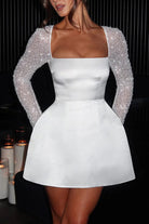 White satin mini dress with beaded sleeves for a stylish casual meeting in fashion