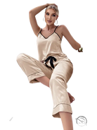 Beige satin pajama set with black trim and black eye mask