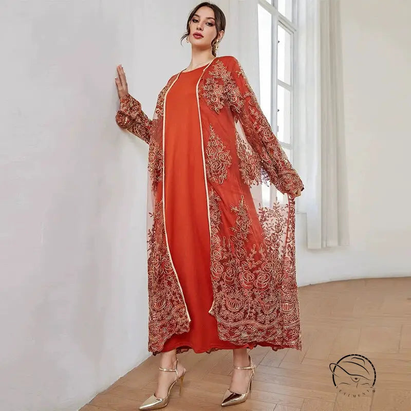 Woman in vibrant orange langry fashion mesh dress with gold embroidery