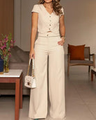Beige two-piece pantsuit featuring short sleeve design, perfect for casual fashion wear
