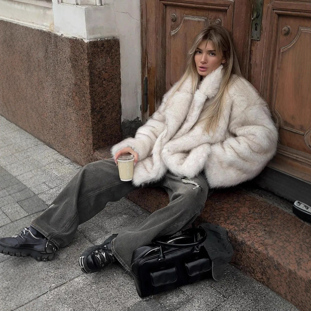 Fashionable faux fur coat with black leather satchel